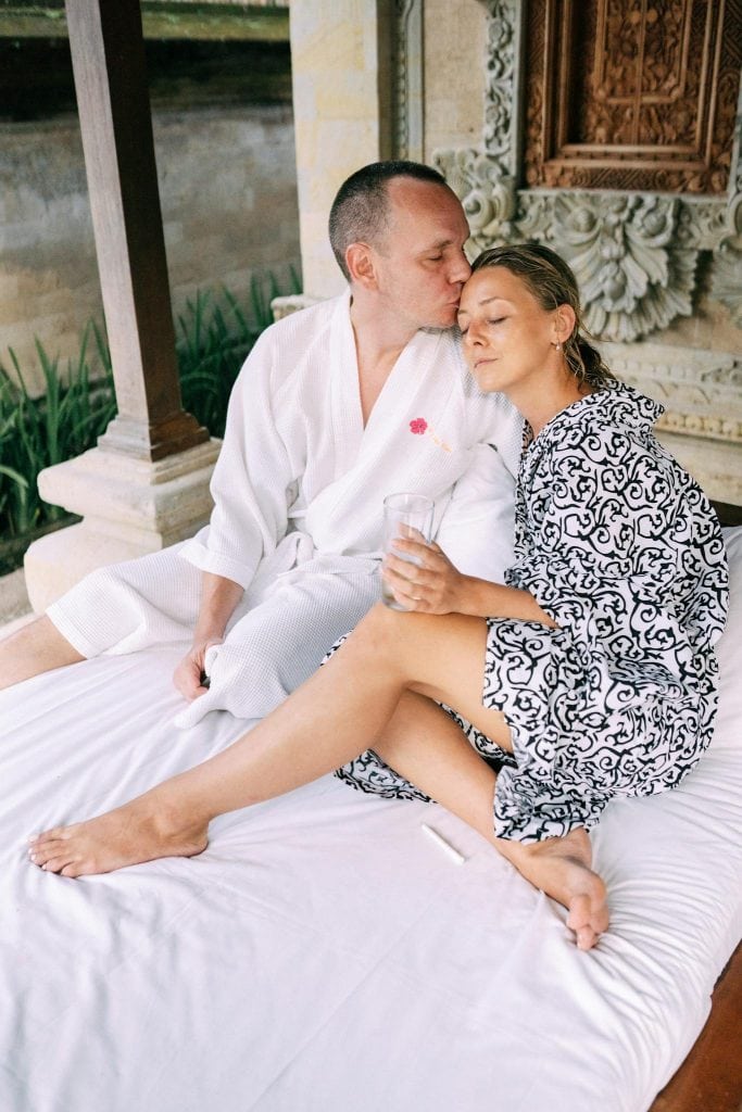 Couple enjoying a serene moment in a luxurious tropical setting, exuding romance.